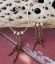 silver and copper hoop chain earrings on distressed red wood