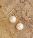 Single white pearls earrings on stone