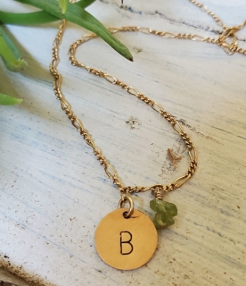 Gold initial charm chain necklace green gemstones on rock