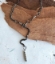 Black gunmetal chain silver stone Y necklace on white table with wood