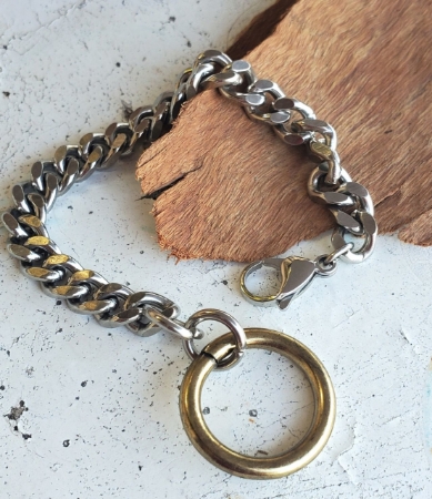 Hefty silver chain gold oring bracelet on table