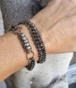 two black multi chain bracelets on wrist