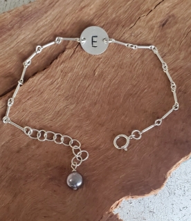 sterling initial bracelet with pearl on wood
