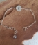 sterling initial bracelet with pearl on wood