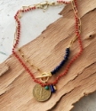 vintage coin blue red green yellow gemstone gold chain necklaces layered on wood
