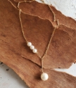 gold chain white pearl drop necklace on wood