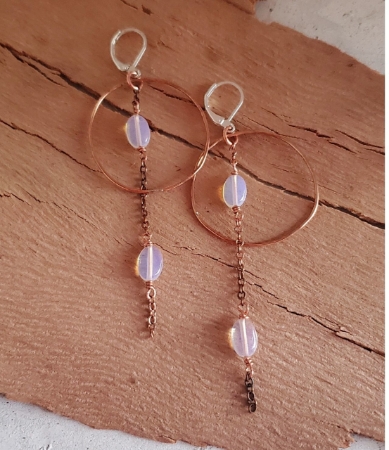 copper hoop opal chain earrings on wood
