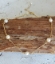 white pearl gold bar necklace draped over wood