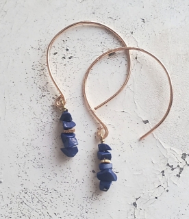 blue lapis gemstone hoop earrings on distressed table