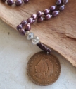  Mexican coin purple pearl necklace close up coin