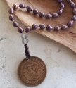  Mexican coin purple pearl necklace on wood