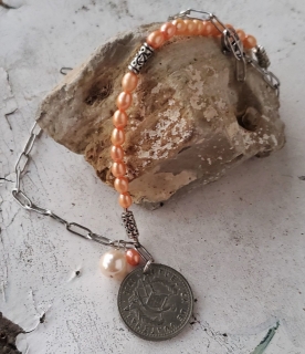 chain pearl coin necklace on rock