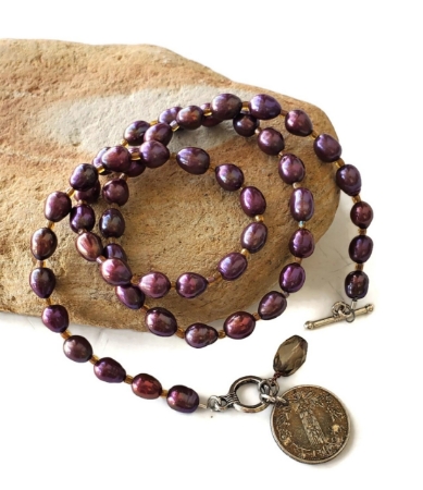 Syria coin purple pearl necklace on rock