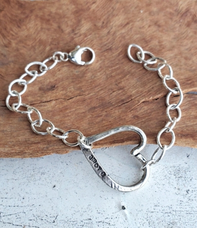 sterling silver heart chain bracelet on wood