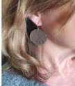 Sterling silver hammered disc earrings on female