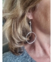 Long silver hoop stick earrings on female