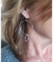 Big hoop little hoop silver earrings on female