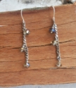 Silver curb chain crystal drop earrings on wood