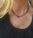 Black gunmetal silver hematite necklace on model with black top
