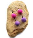 pink & purple felted ball earrings on rock
