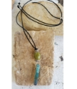 green & teal gemstone stick adjustable black cord necklace on rock