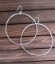 hammered 2" silver hoop earrings on wood