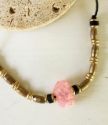 Blush pink black brass bead necklace on rock close up
