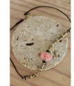 Blush pink black brass bead necklace on rock full view