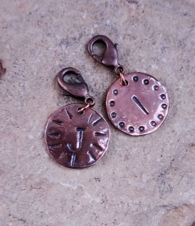 solid copper hammered and stamped with initials on rock