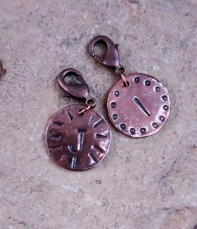 solid copper hammered and stamped with initials on rock
