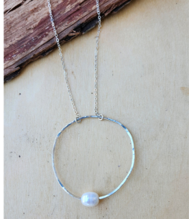 Silver open circle sliding pearl necklace on wood