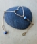 gold bar, peacock pearl, open heart bracelet on black roack