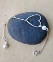silver bar, open heart white pearl bracelet on black rock