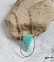 amazonite pendant silver framed necklace on rock