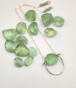 green fluorite gold framed necklace surrounded by stones to show shape and sizes