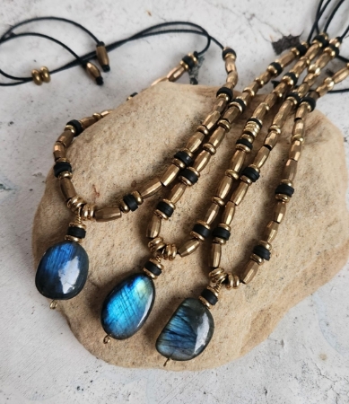 3 labradorite brass bead necklace on a rock