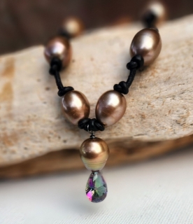 brown pearl necklace knotted on black leather with a rainbow topaz pendant up close