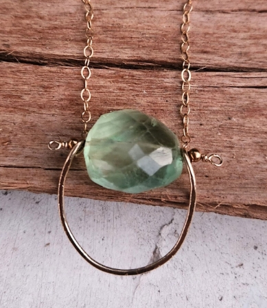 Tumbled green fluorite gold framed necklace close up