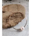 handcrafted gold circle white pearl floating necklace side angle on rock