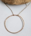 Big gold hammered open circle chain necklace on rock