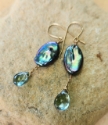 Marquise cut peacock pearl green quartz earrings on rock