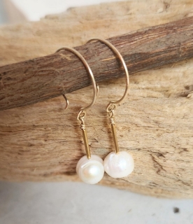 gold mini hoop white pearl stick earrings on wood