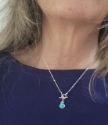 rainbow quartz gold chain toggle necklace on model in navy top