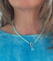 aqua blue beads surround rainbow quartz pendant necklace on model