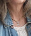 Matte gold beaded rainbow quartz pendant necklace on model