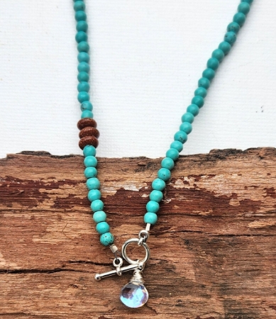 close up turquoise sunstone rainbow quartz toggle necklace on wood