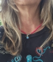 rainbow quartz necklace with deep pink beads on model wearing black emroidered sweatshirt
