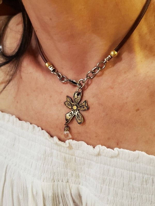 metal flower necklace on neck with peasant top