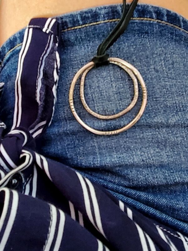 silver circle necklace with denim outfit