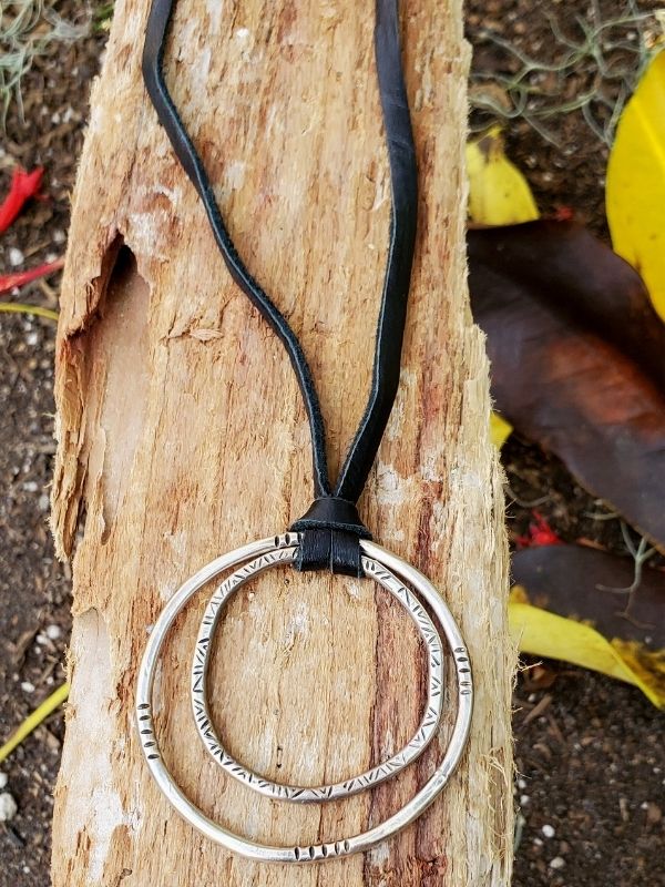 sterling artisan circle necklace on wood